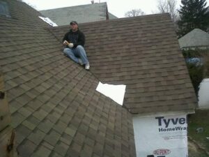 person fixing roof