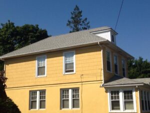 yellow house with tall windows and white trim 2
